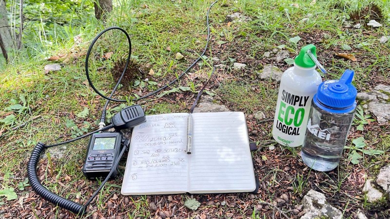 My SOTA equipment: Yaesu FT5-D, logbook, pen and water bottles